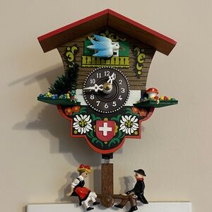 Charming Swiss Chalet Cuckoo Clock with Red and Green Accents